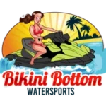 A woman in a bikini riding on top of a jet ski.